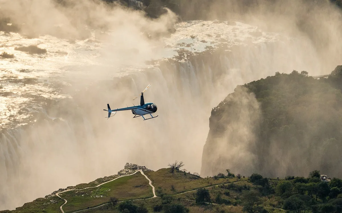 A helicopter above Victoria Falls and the gorge below